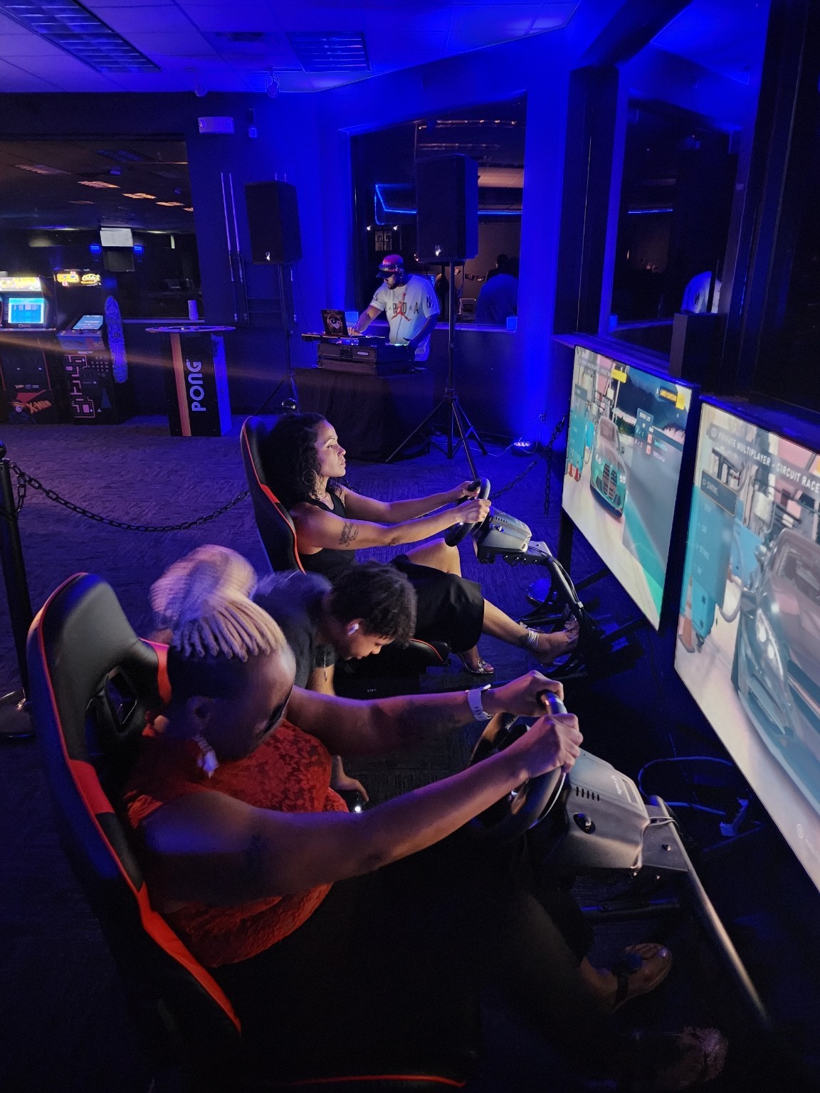 Guests playing side by side on racing simulators