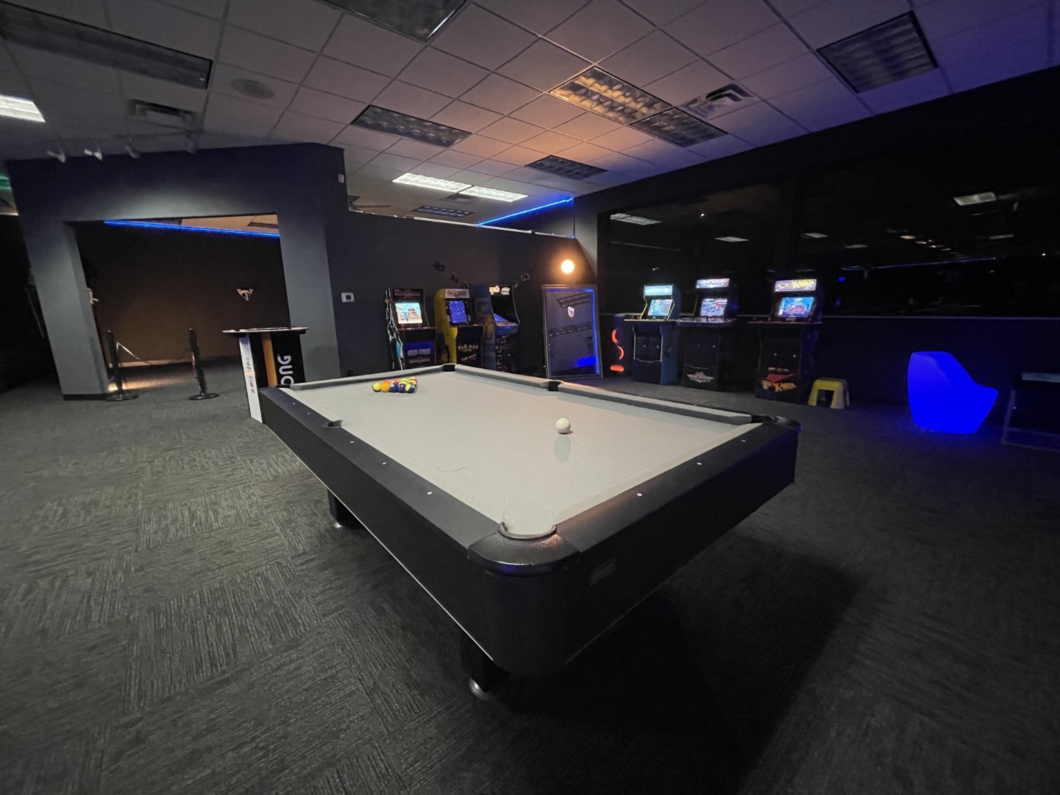 Pool table and arcade cabinets inside The Holloway Experience