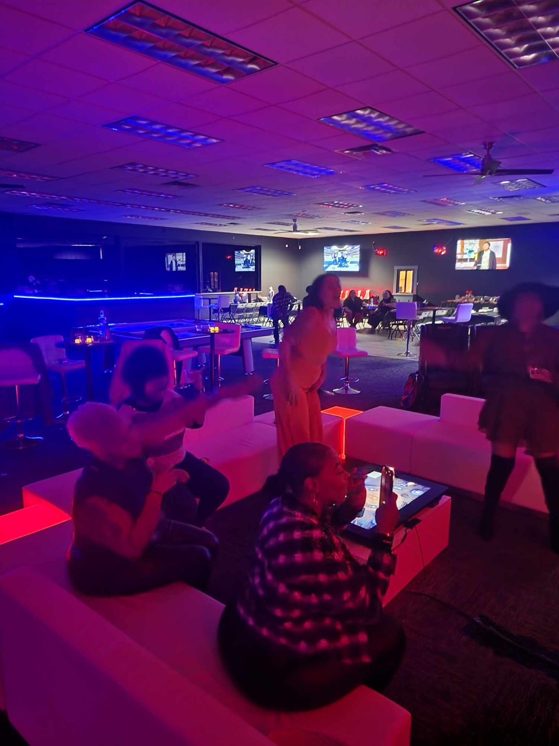 Guests enjoying the neon-lit lounge