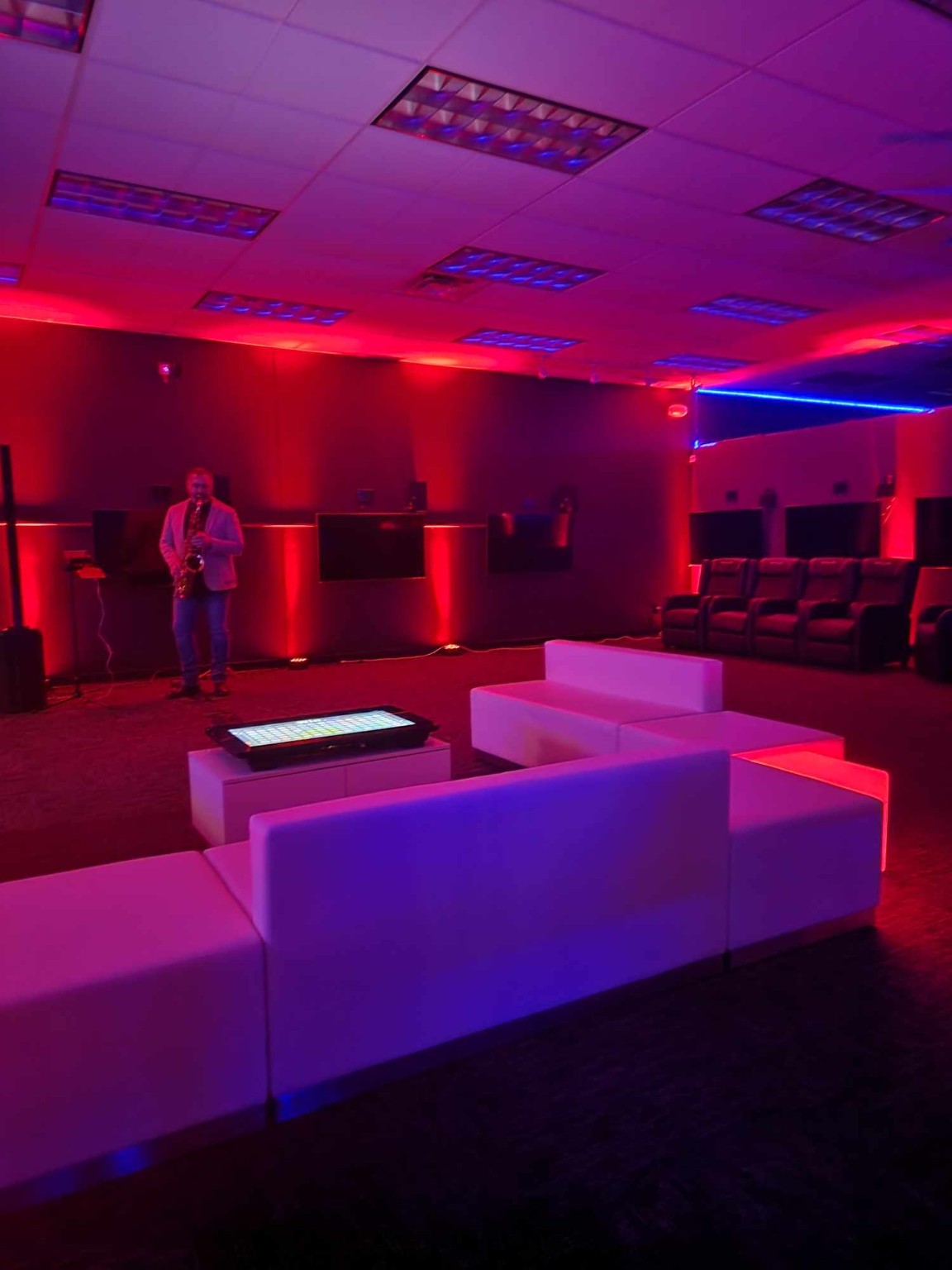 Event setup in the lounge beneath red neon lighting